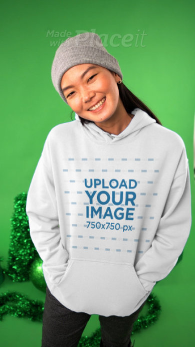 Hoodie Video Featuring a Joyful Woman Posing by Xmas Ornaments 