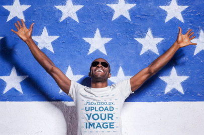 Heathered T-Shirt Mockup of a Cheerful Man Posing Against an American Flag for Labor Day