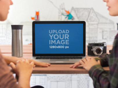 Mockup of a Macbook on a Wooden Desk