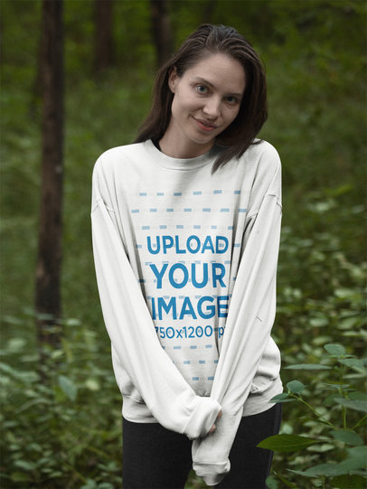Blonde Woman Wearing a Crewneck Sweatshirt Template While in the Woods