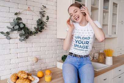 T-Shirt Mockup of a Woman Enjoying Some Music in Her Kitchen