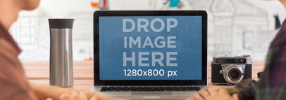 Wide Mockup of a Macbook on a Wooden Desk