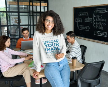 Sweatshirt Mockup Featuring a Student Posing in a Classroom