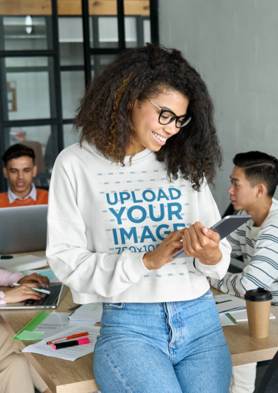 Sweatshirt Mockup Featuring a Happy Woman Checking Her Tablet