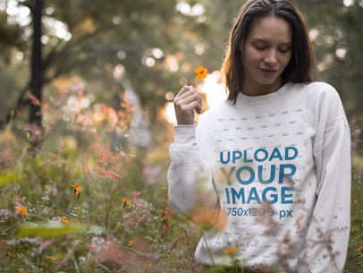 Blonde Woman Wearing a Crewneck Sweatshirt Template While Holding a Flower