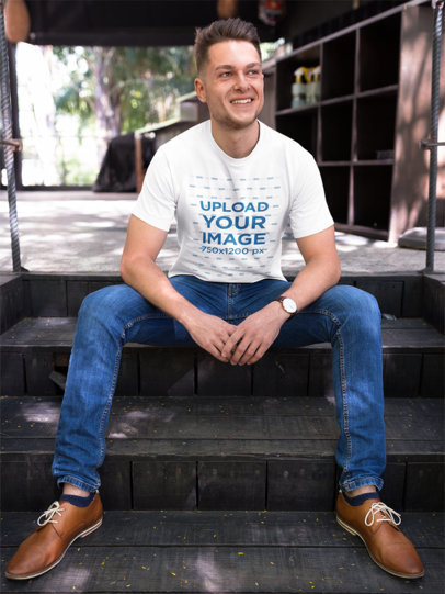 Happy Guy Wearing a Tshirt Template While Sitting on Steps Outdoors