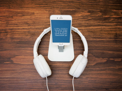 Mockup of a White iPhone 6 on Stand with Headphones