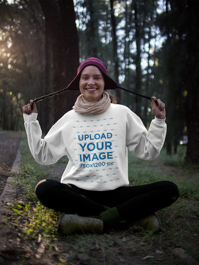 Woman Wearing a Crewneck Sweatshirt Mockup and a Purple Beanie in the Woods