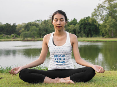 Tank Top Mockup Featuring a Calm Woman Practicing Yoga Near a Lake