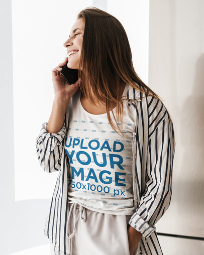 Scoop-Neck T-Shirt Mockup Featuring a Woman Making a Call by a Window