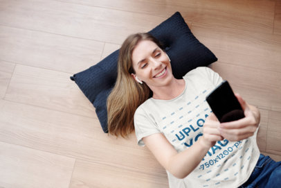 T-Shirt Mockup of a Woman Doing Face Time on the Floor M8344-r-el2