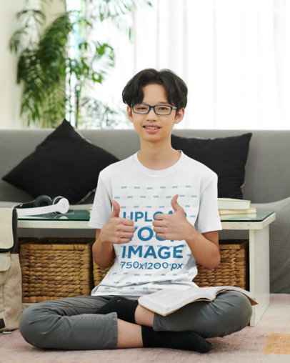 T-Shirt Mockup of a Teen Boy Reading on the Living Room Floor