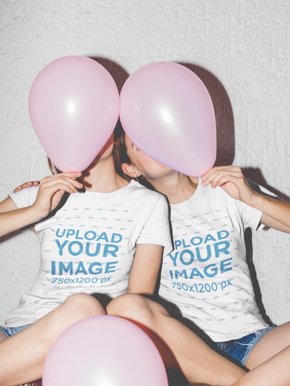 Two Girls Hiding Behind Pink Balloons Wearing Tshirt Mockups a17965