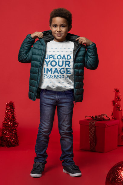 Sweatshirt Mockup Featuring a Boy Posing by Christmas Gift