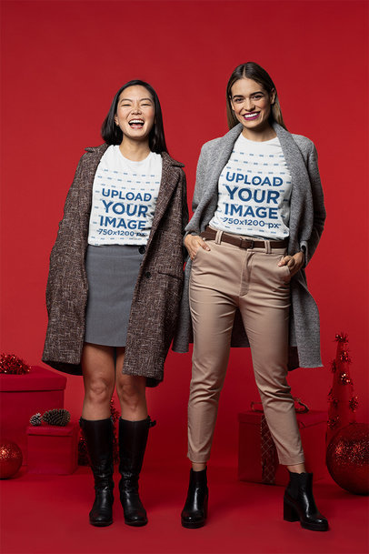 T-Shirt Mockup Featuring Two Friends Hanging in a Christmas-Decorated Setting