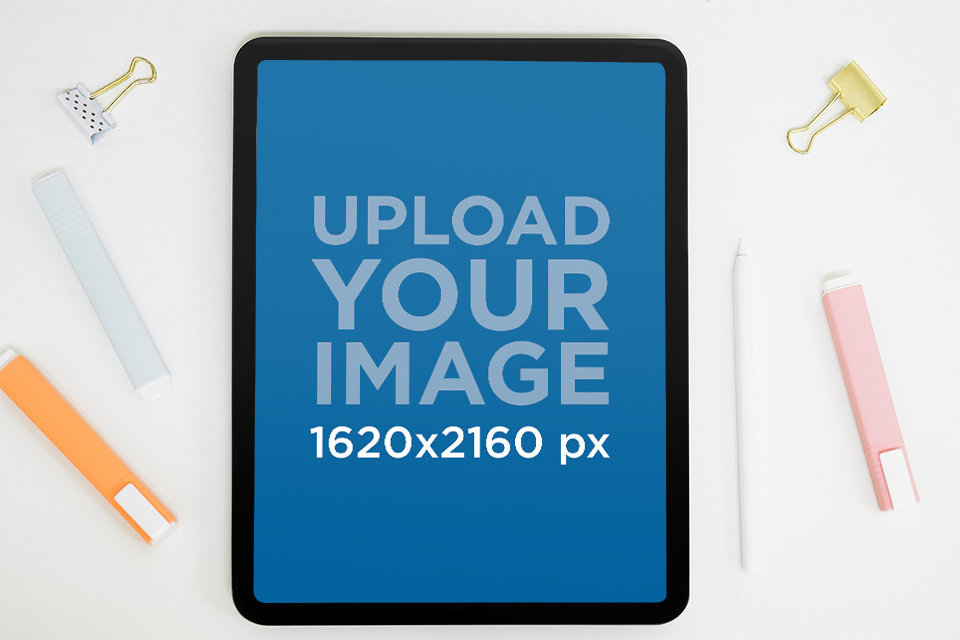 Mockup of an iPad Pro Surrounded by Office Supplies