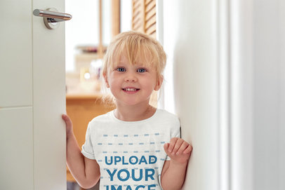 Round-Neck T-Shirt Mockup of a Little Girl Smiling at Home