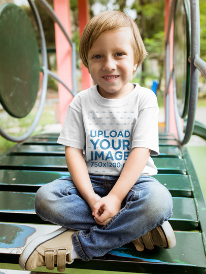 Little Blonde Kid Wearing a Tshirt Mockup at a Playground