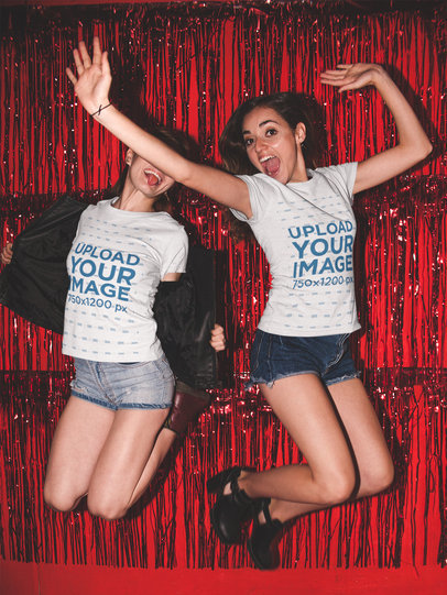 Girls Jumping Wearing Different Round Neck Tees Mockup Against a Red Curtain a17966