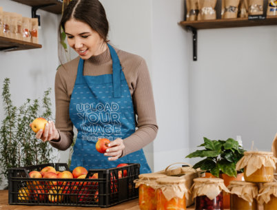 Apron Mockup Featuring a Woman Selecting Apples From a Basket m9909 r-el2