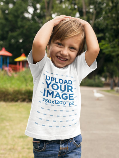 Boy Wearing a T-Shirt Mockup While at a Park with Ducks
