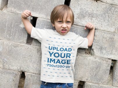 Little Boy Wearing a T-Shirt Mockup while Raising his Arms