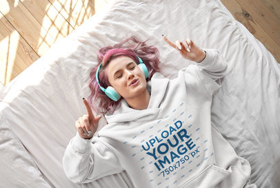Hoodie Mockup of a Woman With Pink Hair Listening to Her Favorite Song on Her Bed m9971-r-el2