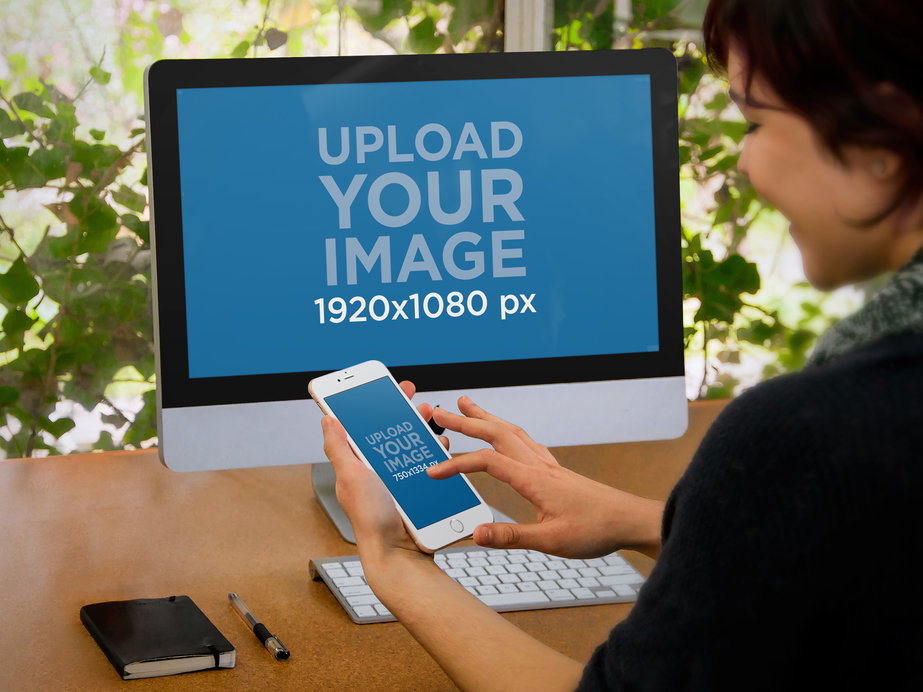Mockup of an iMac and an iPhone Being Used by a Woman