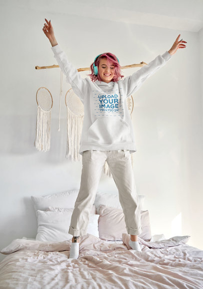 Hoodie Mockup of a Happy Woman with Pink Hair Jumping on a Bed m9743-r-el2