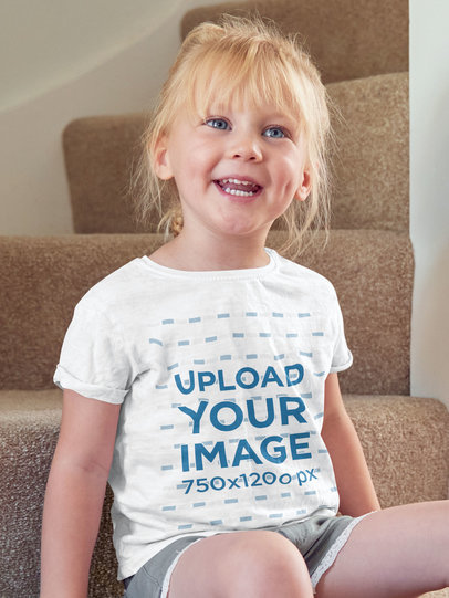 T-Shirt Mockup of a Smiling Little Girl Sitting on the Home Stairs m19574-r-el2