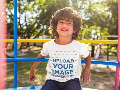 Happy Small Boy Wearing a T-Shirt Mockup While at the Park