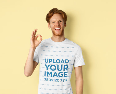 T-Shirt Mockup of a Happy Man Doing an OK Sign in a Studio
