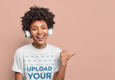 T-Shirt Mockup of a Woman With Headphones Pointing at Something