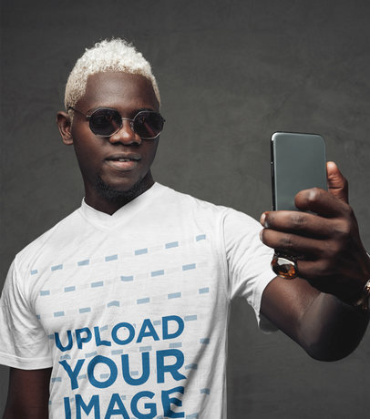 V-Neck Tee Mockup of a Man with Bleached Hair Taking a Selfie