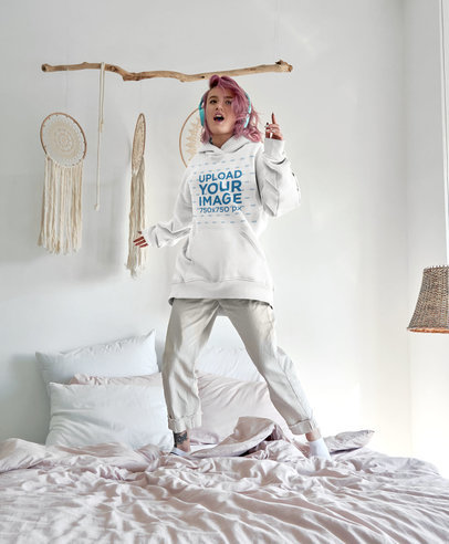 Hoodie Mockup Featuring a Joyful Young Woman Dancing on Her Bed 9972-r-el2