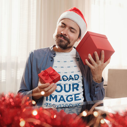 Heathered Tee Mockup of a Joyful Man at Home Holding Christmas Presents