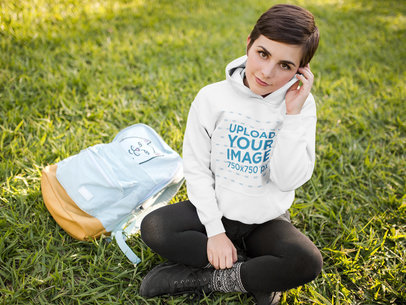Student Woman Wearing a Pullover Hoodie Mockup While at a Park