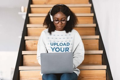 Sweatshirt Mockup of a Woman Using Her Laptop on a Staircase