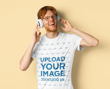 Basic T-Shirt Mockup of a Happy Man Listening to His Favorite Song on His Headphones