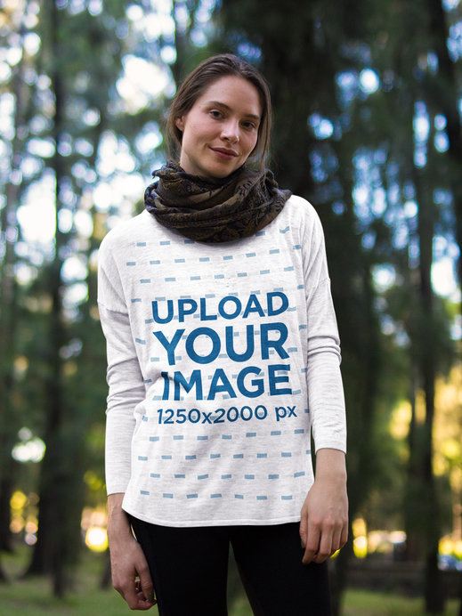 Beautiful Woman Wearing a Bella Canvas Flowy Long Sleeve Tee Mockup in the Woods