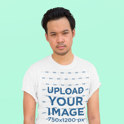 Heathered T-Shirt Mockup Featuring a Man With a Serious Look Posing Against a Plain Background