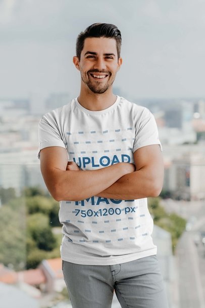 Round-Neck Tee Mockup of a Smiling Man Posing with Crossed Arms