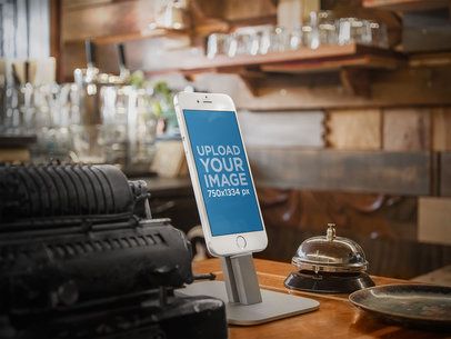Mockup of an iPhone 6 on a Stand at a Vintage Shop