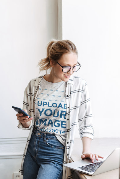 Heathered T-Shirt Mockup Featuring a Woman Working 