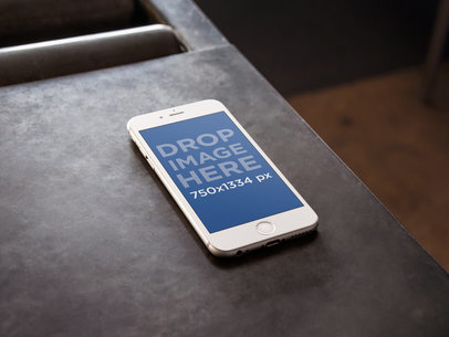 mockup of an iPhone 6 on a Metal Work Table