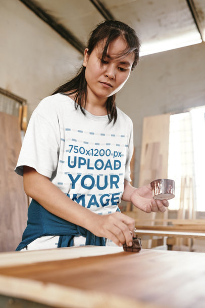 Round-Neck Tee Mockup of a Woman Applying Varnish to a Surface m11568 r-el2