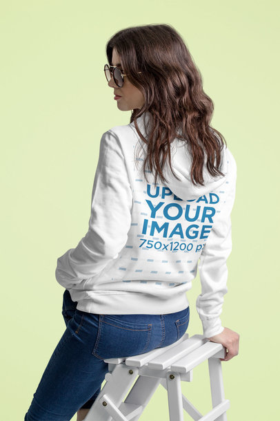Back-View Hoodie Mockup Featuring a Woman Sitting on a Small Ladder 5311 el1