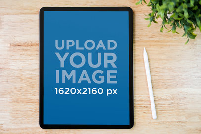 iPad Mockup Featuring a Wooden Surface and a Stylus M20264-r-el2