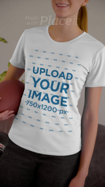 T-Shirt Video of a Woman at Home Holding a Football for The Big Game 4504v