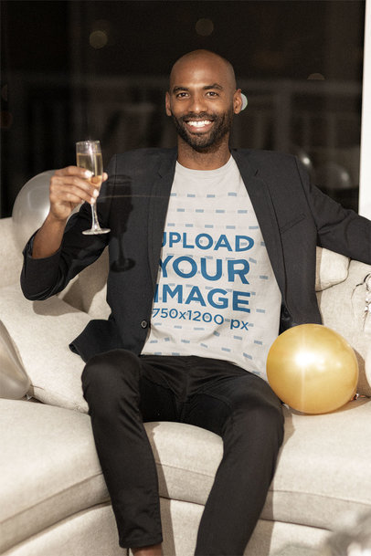 T-Shirt Mockup Featuring a Happy Man Holding a Champagne Glass
